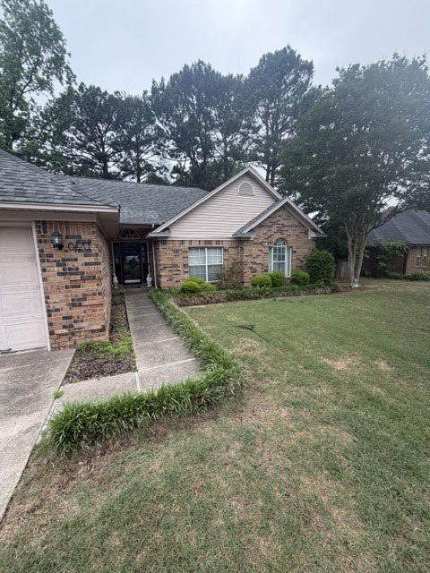 Front of brick home before Spearmon landscape work