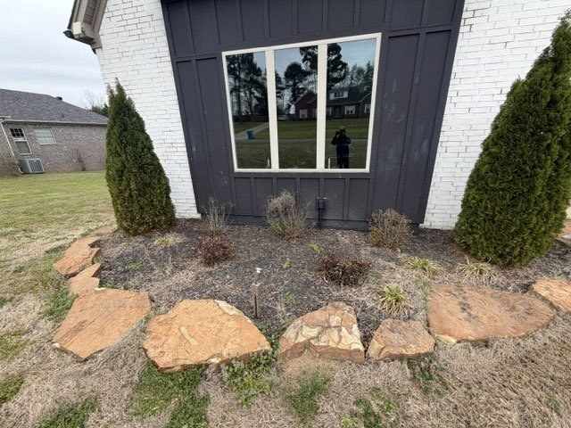 Landscape bed with dark mulch before rock conversion